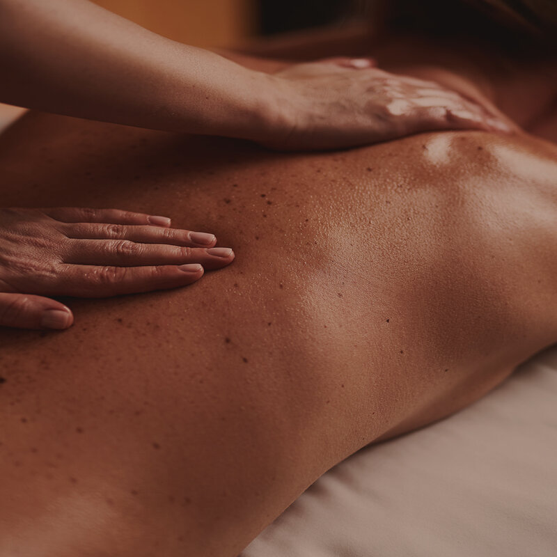 A person getting a hot stone massage